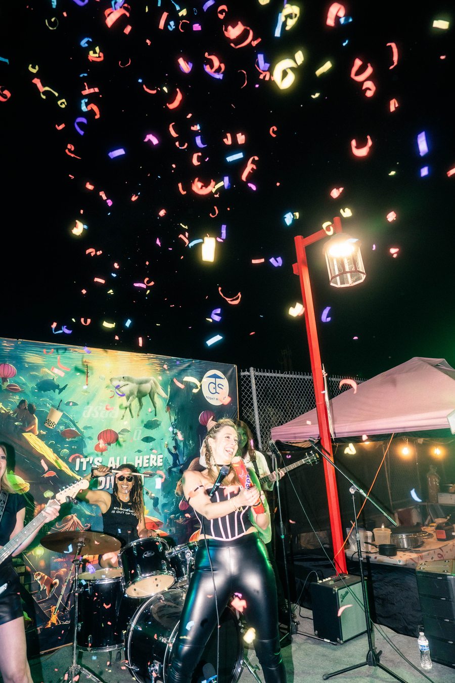Live band performing with confetti at DS Night Market Saturday