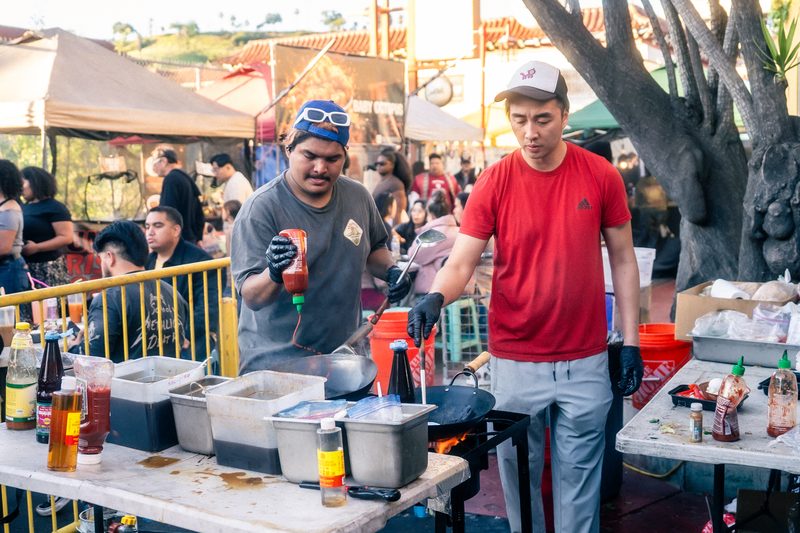 Cooks working a food stall at DS Night Market