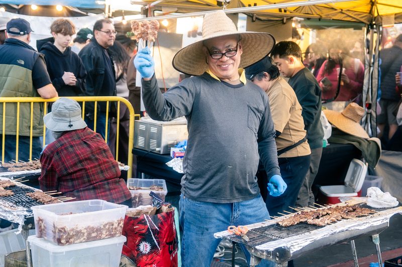 Smiling vendor at DS Night Market