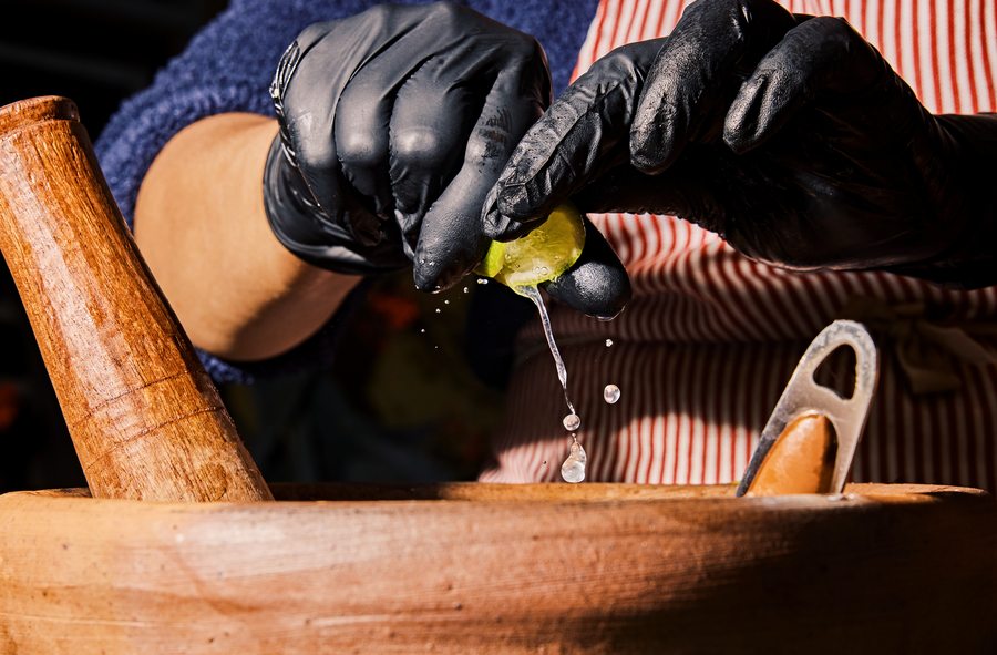Fresh lime being squeezed into a mortar for Thai food at DS Night Market